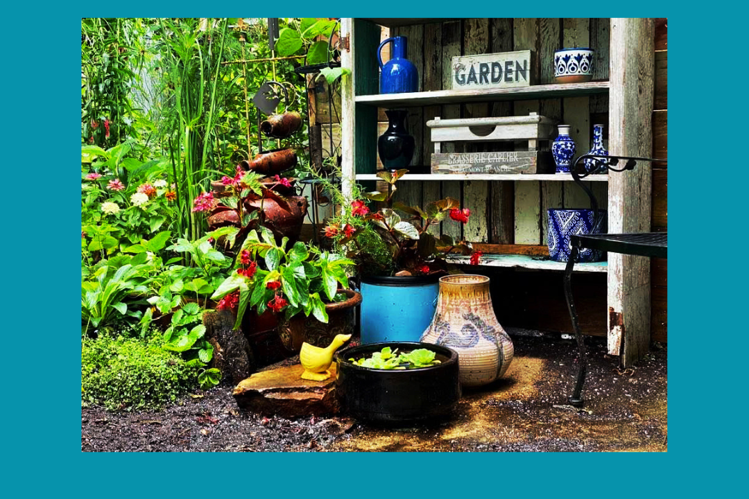 Garden shelf with plants and decorations.