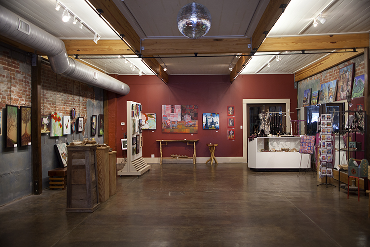 A room with many paintings on the walls